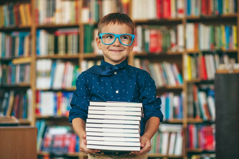 Boy with stack of books