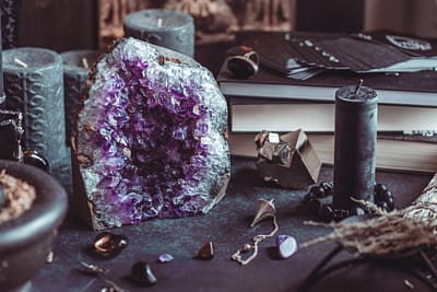 Amethyst Druze on a witch’s altar for a magical ritual among crystals and black candles. Amethyst Druze on a witch's altar for a magical ritual among crystals and black candles.